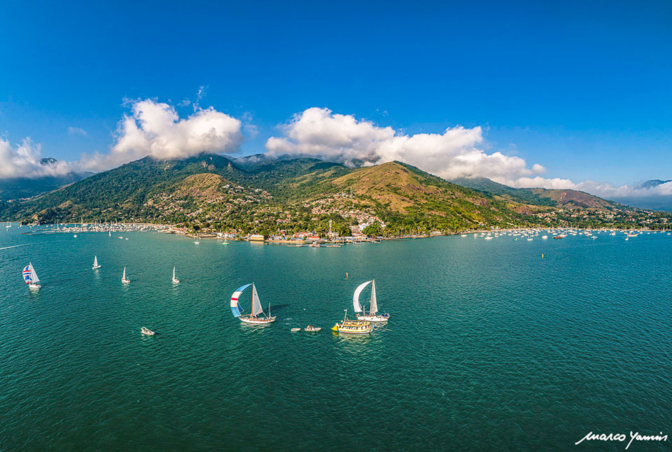 Imagem aérea de Ilhabela por Marco Yamin com veleiros ao mar